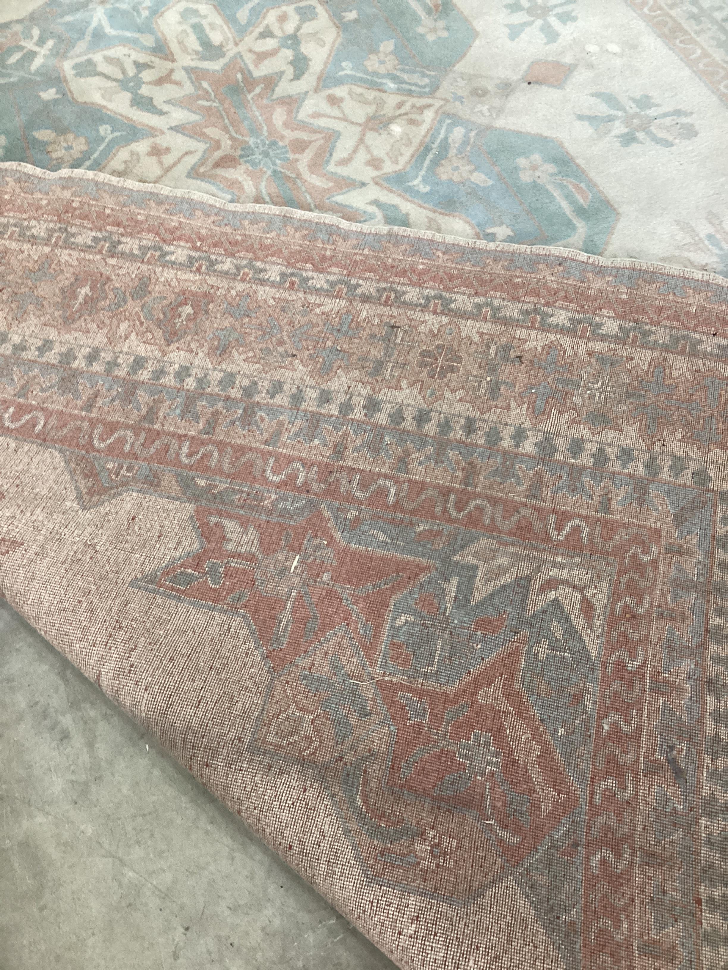 A Turkish ivory ground carpet, 386 x 264cm